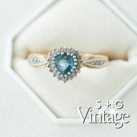 Vintage-style ring with heart-shaped blue gemstone and diamond accents on a white background - seolgold