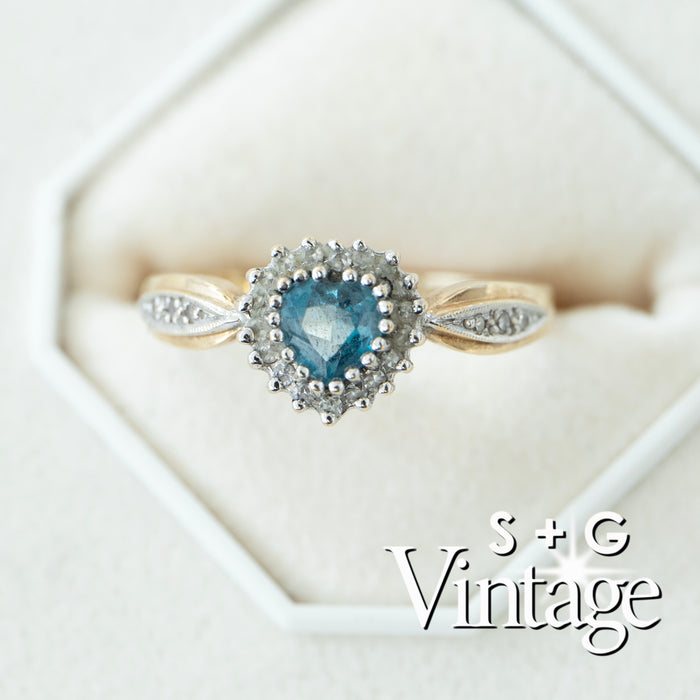 Vintage-style ring with heart-shaped blue gemstone and diamond accents on a white background - seolgold