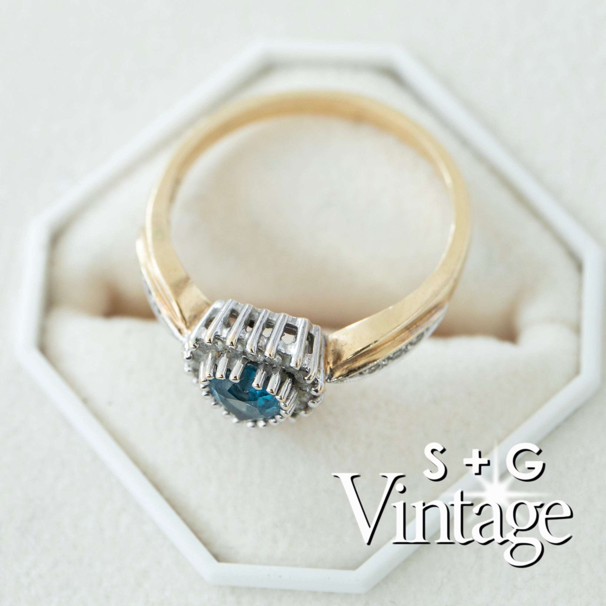 Gold ring with blue gemstone in a hexagonal white box, branded 'S + G Vintage' - seolgold