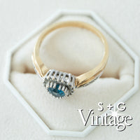 Gold ring with blue gemstone in a hexagonal white box, branded 'S + G Vintage' - seolgold