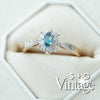 Diamond ring with blue gemstone in a hexagonal box, featuring 'S + G Vintage' branding - seolgold