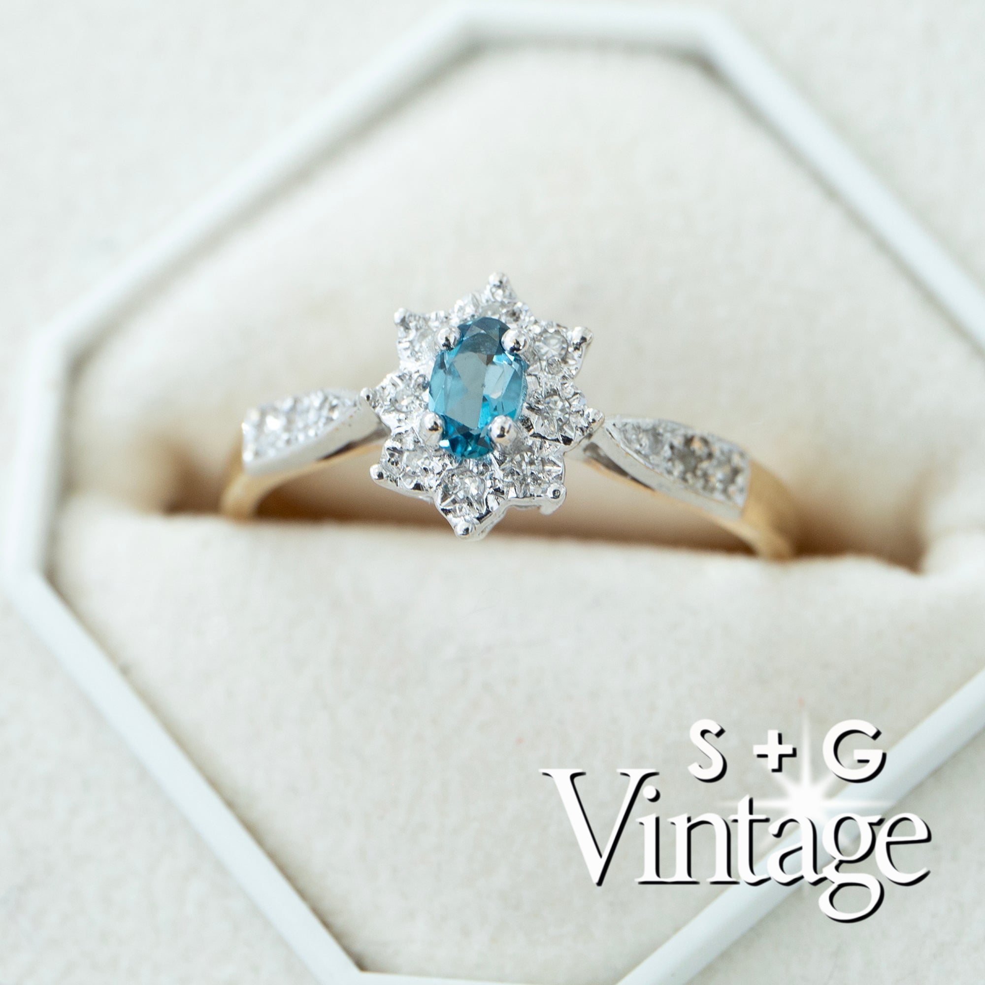 Diamond ring with blue gemstone in a hexagonal box, featuring 'S + G Vintage' branding - seolgold