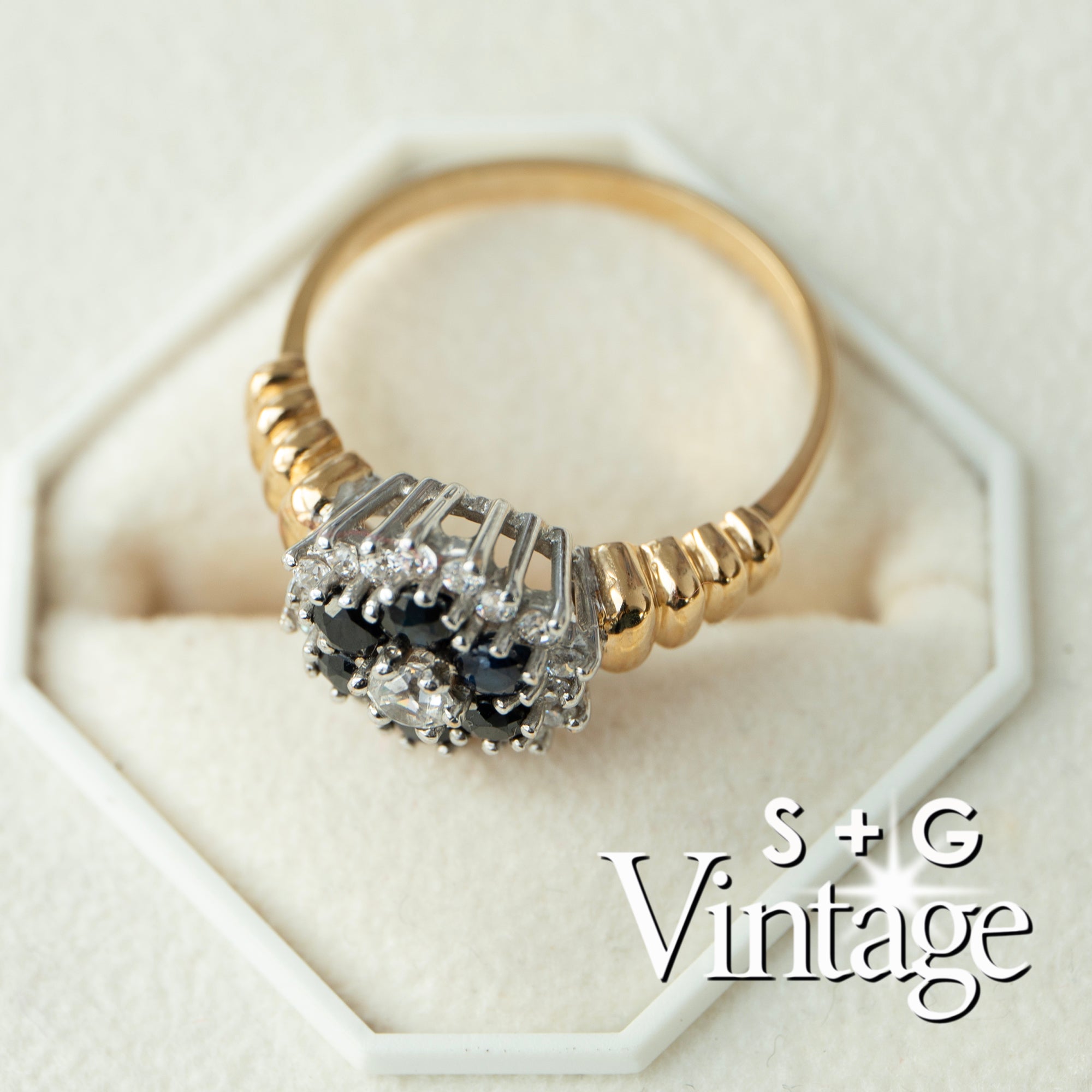 Gold ring with black and white gemstones on a white background, featuring 'S + G Vintage' branding - seolgold