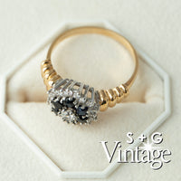 Gold ring with black and white gemstones on a white background, featuring 'S + G Vintage' branding - seolgold