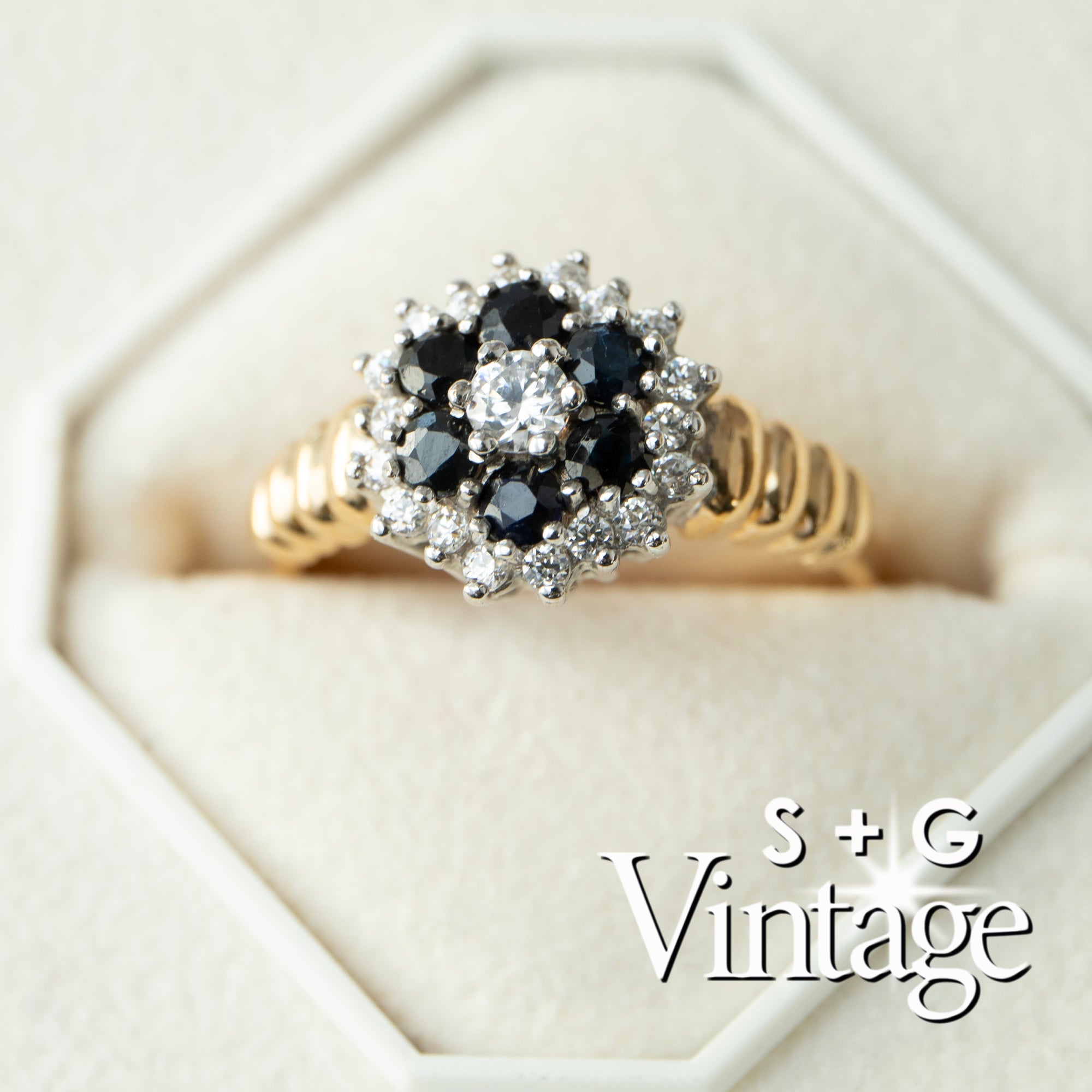 Gold ring with black gemstone and diamonds on a white background, featuring 'S + G Vintage' branding - seolgold