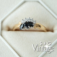 Gold ring with black gemstone and diamonds in a hexagonal box, featuring 'S + G Vintage' branding - seolgold