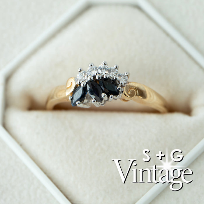 Gold ring with black gemstone and diamonds in a hexagonal box, featuring 'S + G Vintage' branding - seolgold