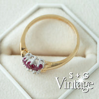 Gold ring with red gemstones on a white hexagonal stand, featuring 'S + G Vintage' branding - seolgold