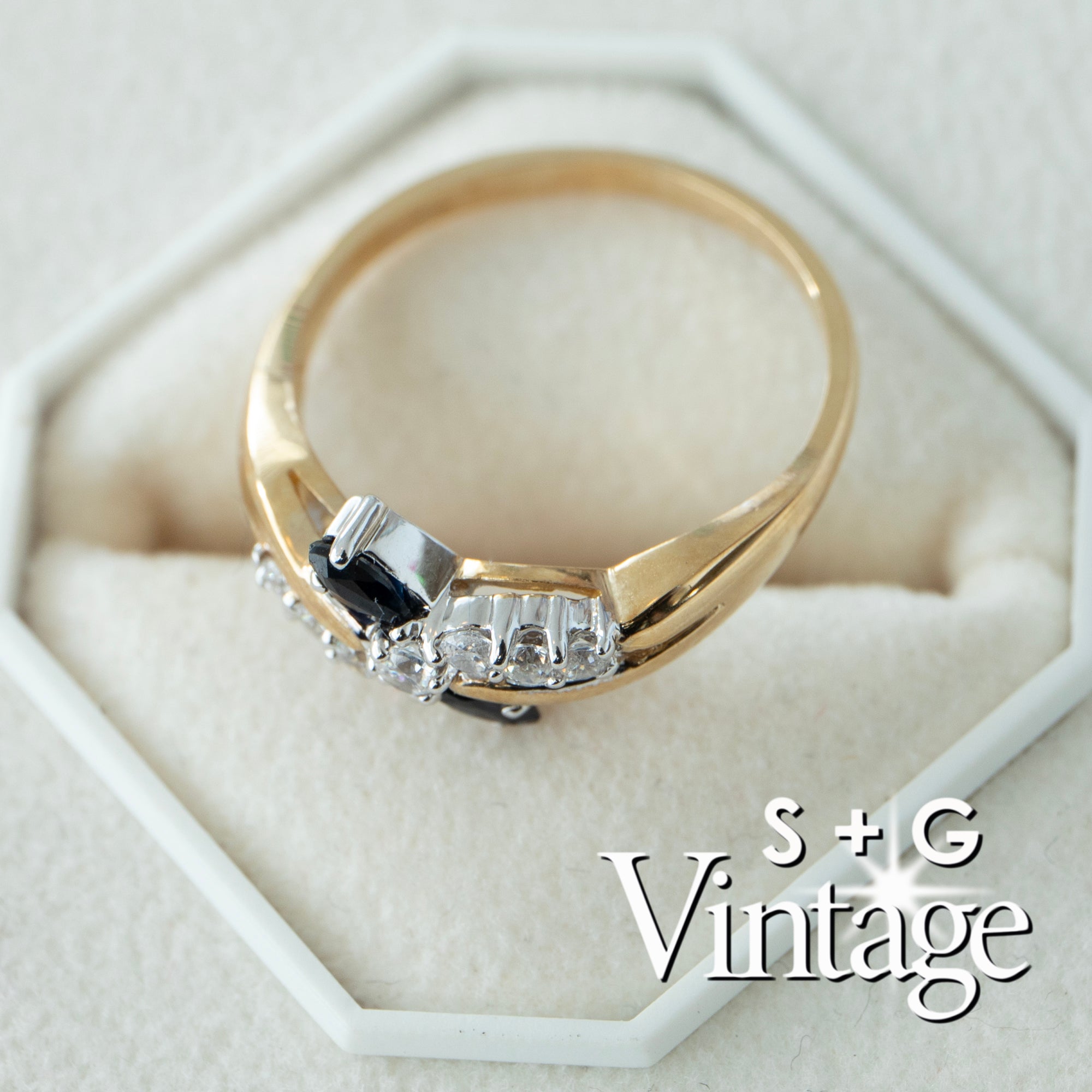 Gold ring with diamonds on a white hexagonal stand, featuring 'S + G Vintage' branding - seolgold