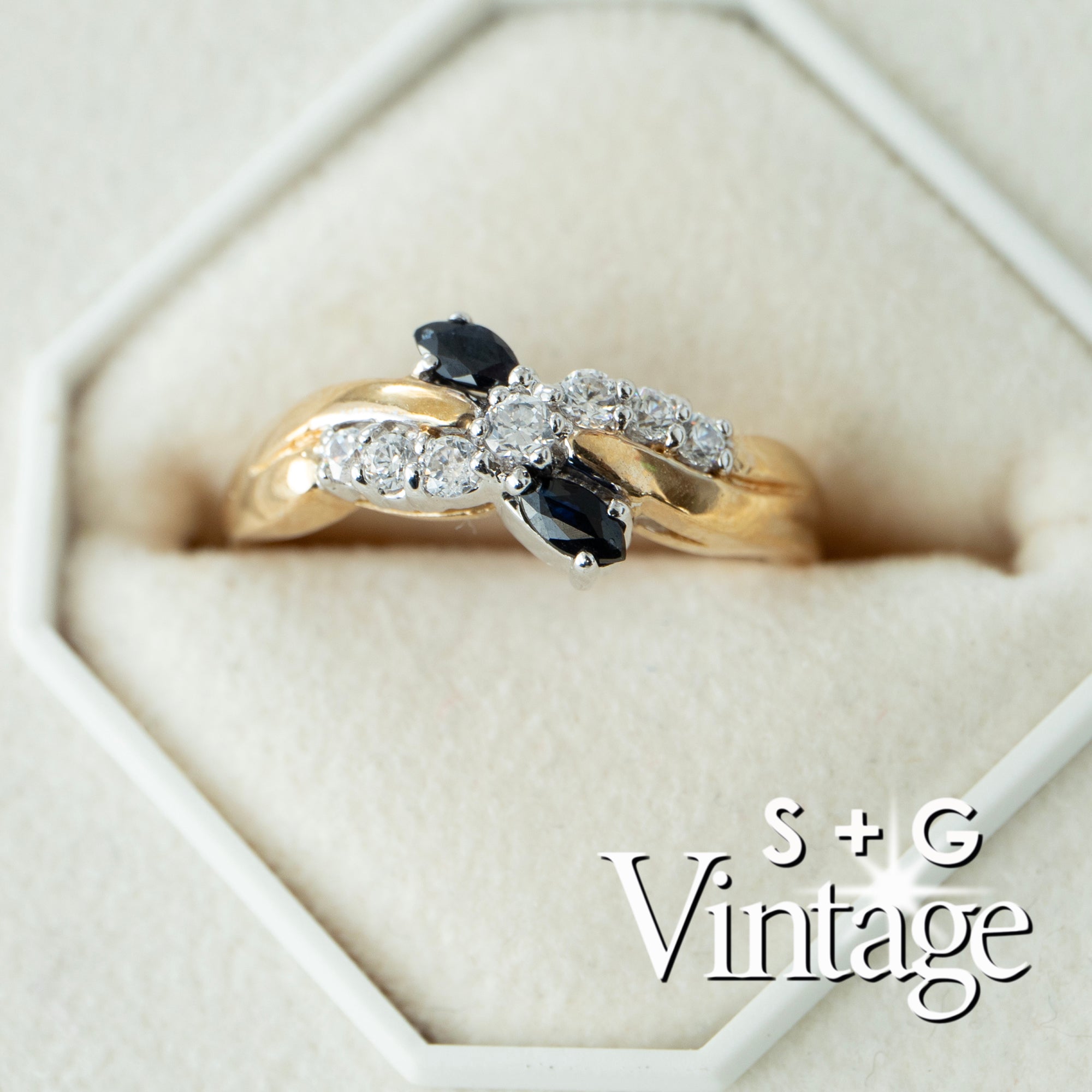 Gold ring with black and clear gemstones in a hexagonal box, featuring 'S + G Vintage' branding - seolgold