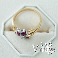 Gold ring with red gemstones and diamonds on a white hexagonal stand, branded 'S + G Vintage' - seolgold