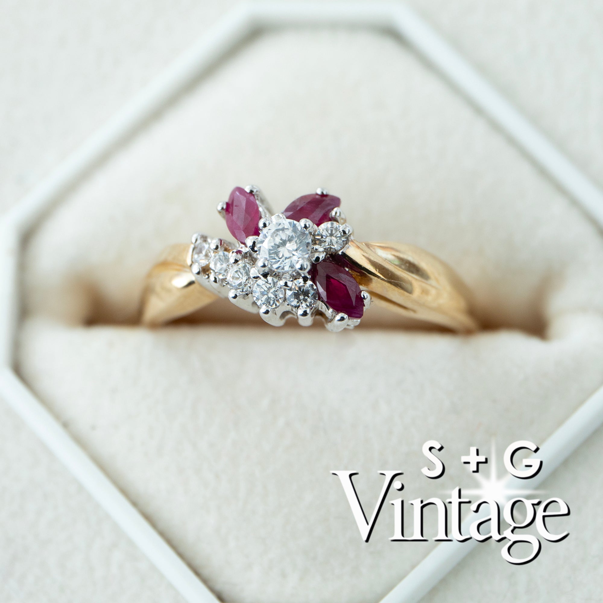 Gold ring with red gemstones and diamonds in a hexagonal box, branded 'S + G Vintage' - seolgold