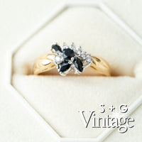 Gold ring with black gemstones and diamonds on a white background, featuring 'S + G Vintage' branding - seolgold