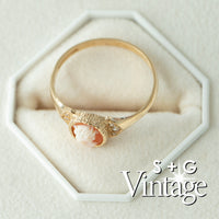 Gold ring with a cameo design on a white hexagonal stand, branded 'S + G Vintage' - seolgold