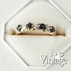 Gold ring with black gemstones on a white background, featuring 'S + G Vintage' branding - seolgold
