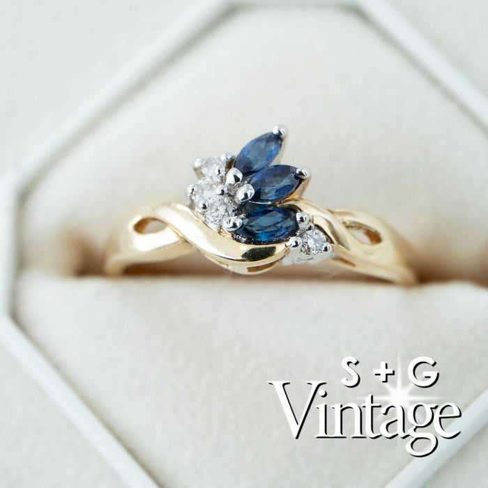 Gold ring with blue gemstones and diamonds on a white background, featuring 'S + G Vintage' branding - seolgold