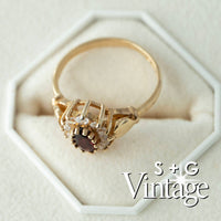 Gold ring with a heart-shaped center stone on a white hexagonal stand, branded 'S + G Vintage' - seolgold